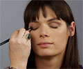 Betsy applying eye shadow to Sara